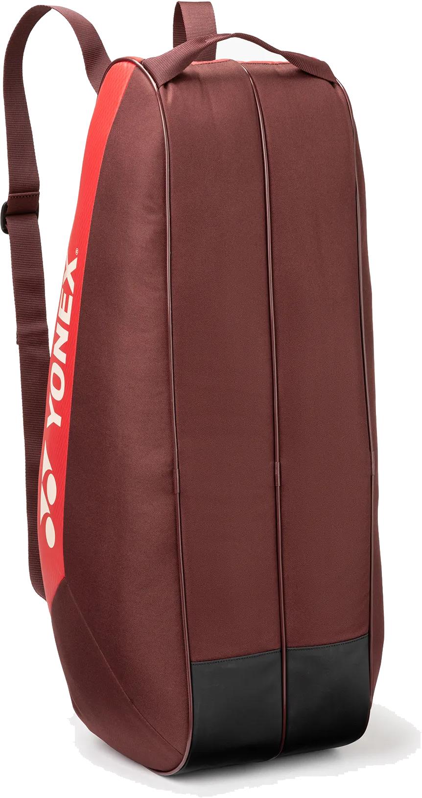 The Yonex 42526EX Team 6 Racket Badminton Bag in Ruby Red features a white Yonex logo, shoulder strap, top handle, and reinforced black base. Holds up to 6 rackets for convenience and durability.