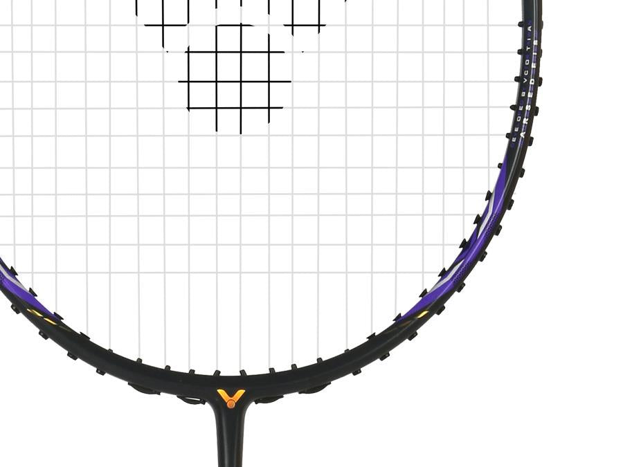 Close-up of the Victor Auraspeed 7100 4U Badminton Racket by Victor, featuring a black frame with purple accents, white strings, and a logo at the base, displayed on a white background.