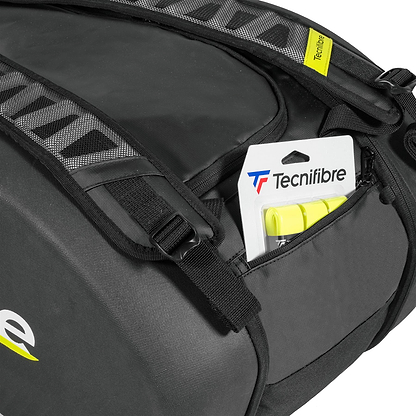 A close-up of the spacious Tecnifibre Reform L Badminton Racket Bag in black, made from durable EVA material, with a Tecnifibre-branded yellow tennis ball package partially visible in an outer zip pocket.