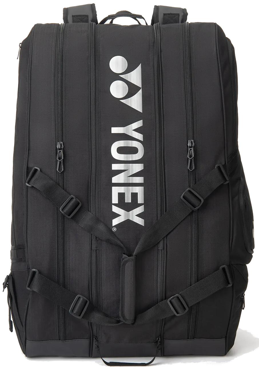 The Yonex BA726212EX Gearlogic 12 Racket Badminton Bag in black features four vertical zippers, adjustable straps, and bold white Yonex branding—ideal for stylishly carrying your gear to any badminton tournament.