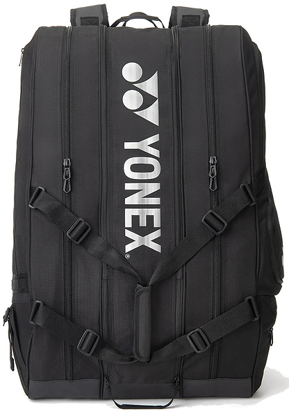 The Yonex BA726212EX Gearlogic 12 Racket Badminton Bag in black features four vertical zippers, adjustable straps, and bold white Yonex branding—ideal for stylishly carrying your gear to any badminton tournament.