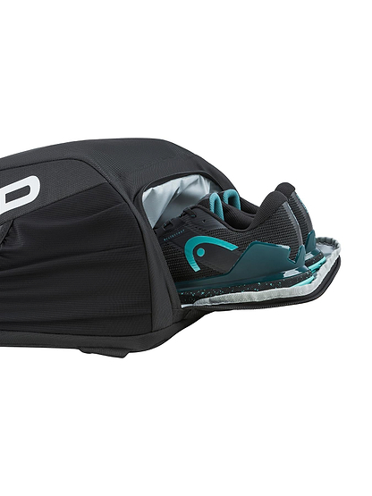 The HEAD Tour 25L Badminton Backpack - Black by HEAD is shown partially open, displaying a pair of black and teal athletic shoes in its dedicated shoe compartment.