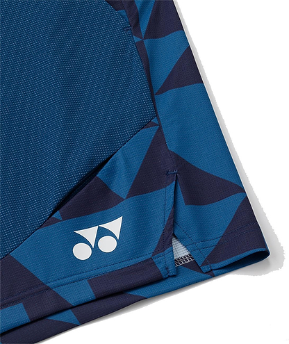 Close-up of the bottom hem of Yonex 15240YX Knit Men's Badminton Shorts in indigo blue, showing a geometric pattern and a white Yonex logo near the edge.