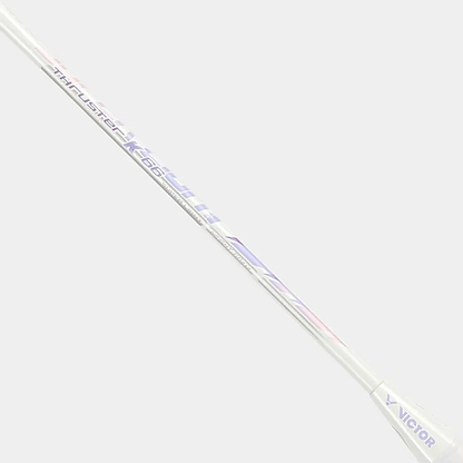 A close-up of the Victor Thruster K 66 AJ 7U Badminton Racket shaft in white/purple, featuring the Victor brand and model printed boldly.