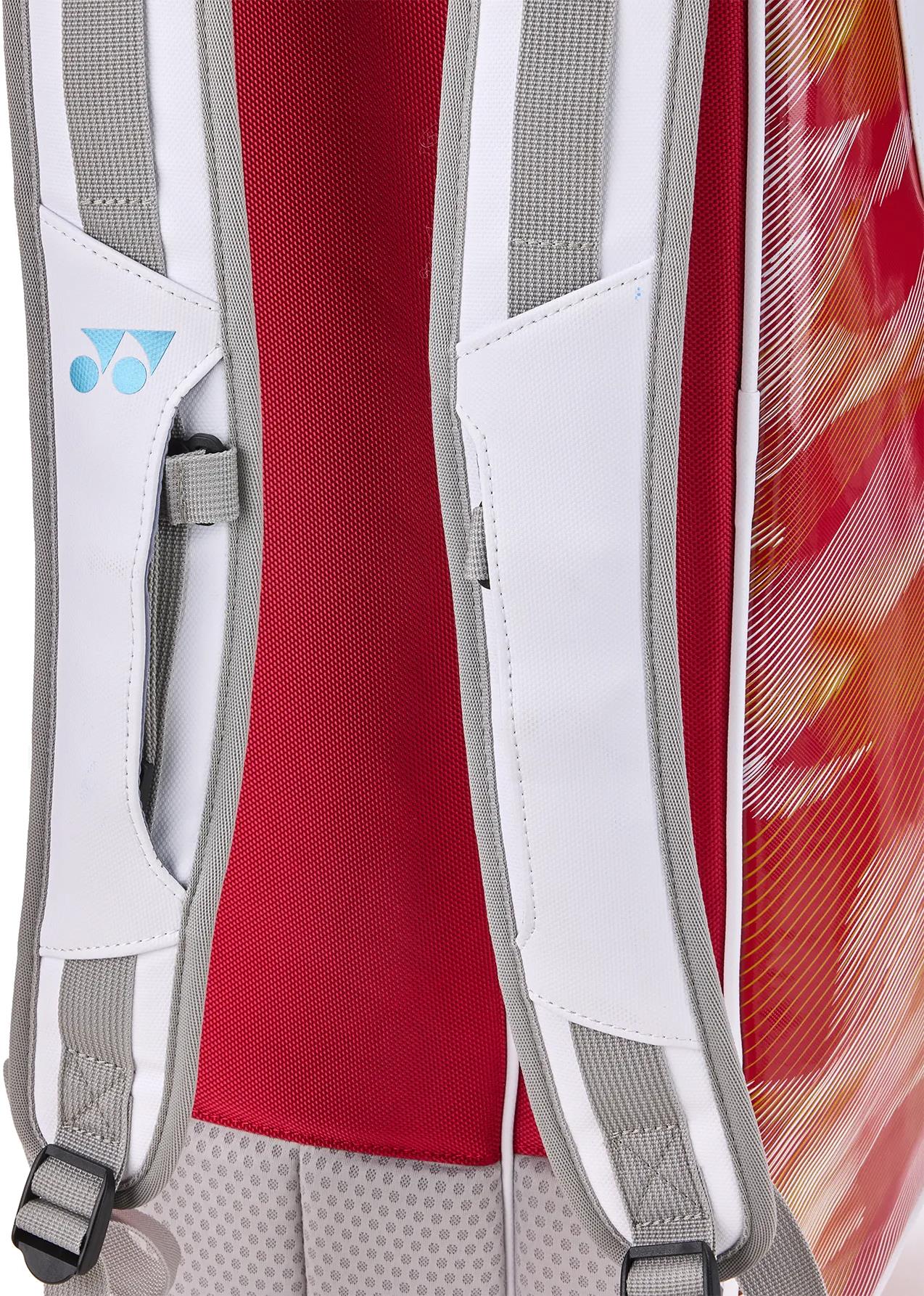 Close-up of Yonex 02626EX Expert 6 Racket Badminton Bag’s shoulder straps with white and gray padded mesh, blue logo, red back panel, vibrant red-orange sides, and Thermo Guard protection.