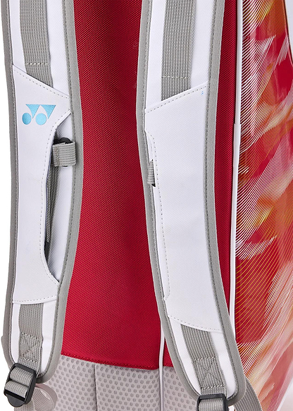 Close-up of Yonex 02626EX Expert 6 Racket Badminton Bag’s shoulder straps with white and gray padded mesh, blue logo, red back panel, vibrant red-orange sides, and Thermo Guard protection.