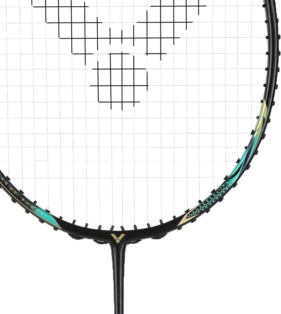 Close-up of the Victor Thruster F C Ultra CX 4U Badminton Racket by Victor, featuring a black frame with gold accents and white strings adorned with a bold black geometric pattern for a sleek, modern look.