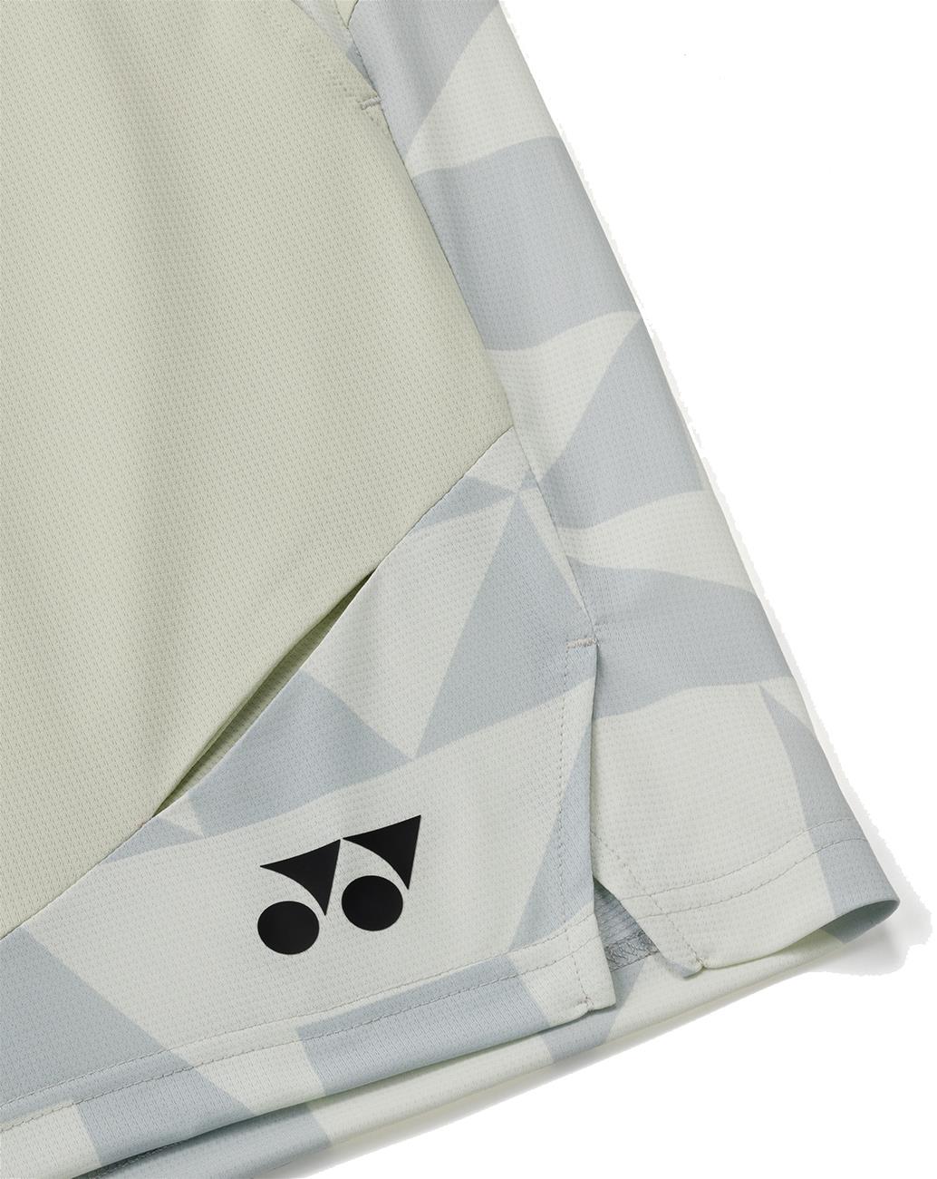 A close-up of Yonex 15240YX Knit Men's Badminton Shorts in champagne, featuring a geometric pattern, black Yonex logo, and breathable, quick-drying fabric with stitched seams—ideal for badminton.