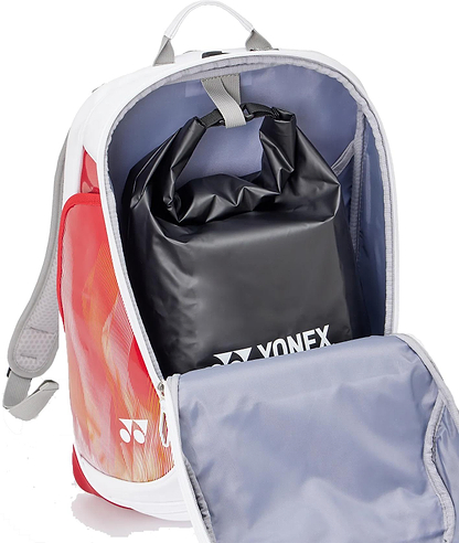 The Yonex 02612EX Expert Badminton Backpack - White is shown with its front compartment open, revealing a black Yonex roll-top pouch inside. The stylish bag, by Yonex, features white, red, and orange accents and adjustable shoulder straps.