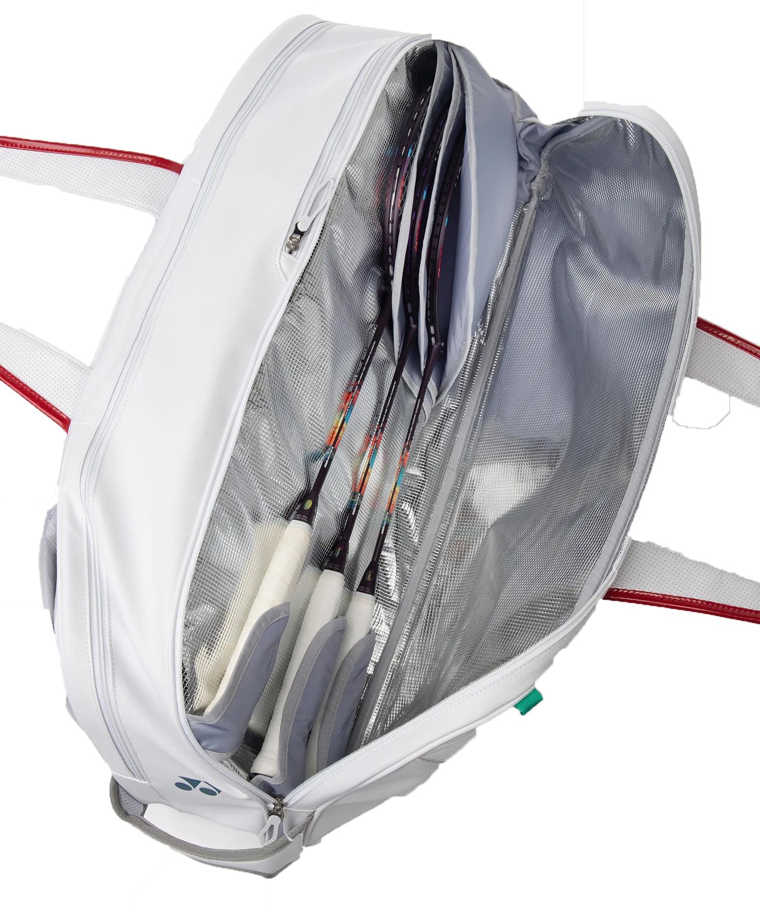 The Yonex 02631WEX Expert Tournament Badminton Bag in white is unzipped to show several neatly stored racquets, a mesh divider, and Thermo Guard technology that protects your gear from temperature changes.