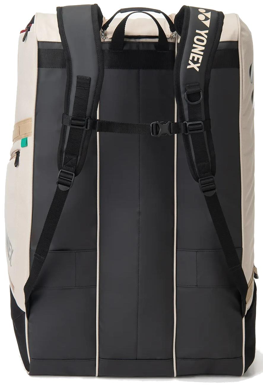 The Yonex BA726212EX Gearlogic 12 Racket Badminton Bag in beige is shown from the back, featuring padded shoulder straps, a chest strap, side pockets, and a top carrying handle.