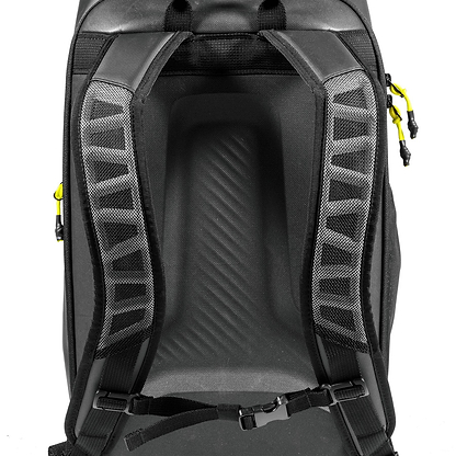 Close-up of the Tecnifibre Reform Badminton Backpack - Black, showing padded mesh shoulder straps with a chest buckle and yellow zipper pulls on the sides. This backpack by Tecnifibre is made from durable EVA material.