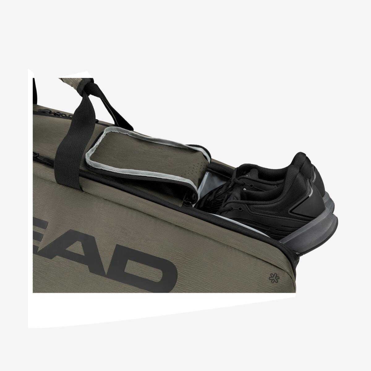 A tennis bag from the brand "HEAD" is open, showing black sneakers inside. This HEAD Pro X Badminton Bag L - TYBK features an olive green exterior with black straps and a white interior. It provides generous storage for your badminton rackets and includes CCT+ Climate Control Technology to ensure their protection.