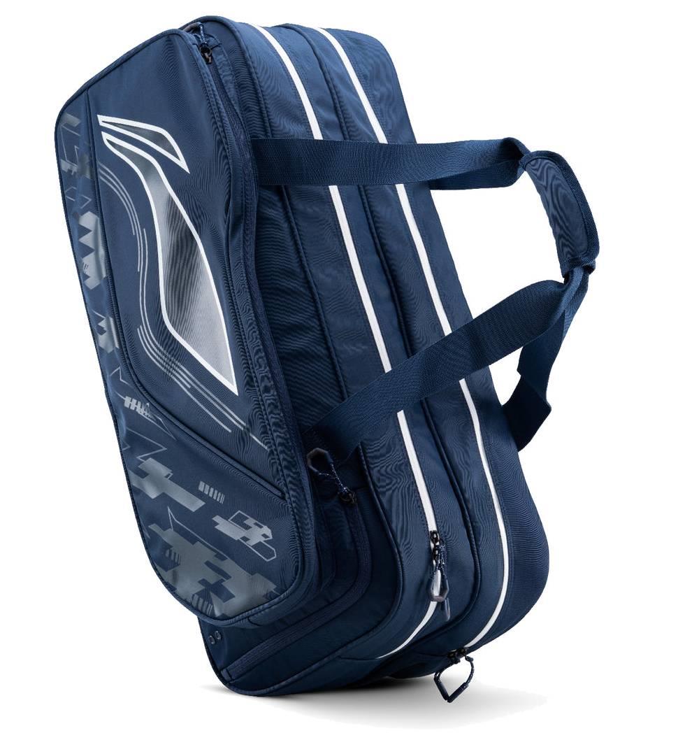 The Li-Ning Team 6 Racket Badminton Bag in navy blue features white stripes, graphic patterns, two zippered compartments, and dual shoulder straps—ideal for carrying up to 6 rackets.