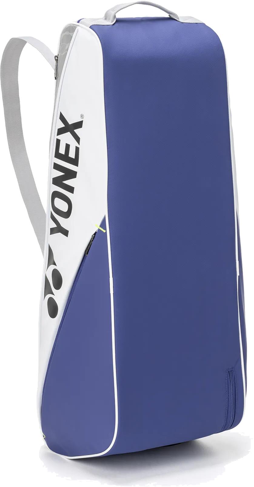 The Yonex BA52526EX Club 6 Racket Badminton Bag in white/blue features a top handle, shoulder strap, and vertical Yonex branding on the white side, perfect for stylishly carrying your badminton gear.