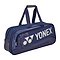 The Yonex 02531WEX Expert Tournament Badminton Bag in navy blue, ideal for tournament players, boasts shoulder straps, a prominent Yonex logo, multiple zippered compartments, and a textured base for efficient sports equipment storage.