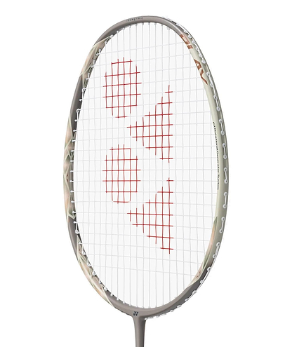 Close-up of the Yonex Astrox 77 Play 4U Badminton Racket in light beige, featuring a gray frame and red geometric string pattern. Suitable for beginners, this Yonex racket is photographed against a plain white background.