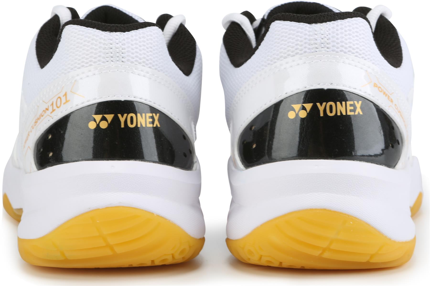A close-up of the Yonex Power Cushion SHB 101 Badminton Shoes in white and gold shows the Yonex logo on the heel and highlights their Power Cushion technology for superior shock absorption.