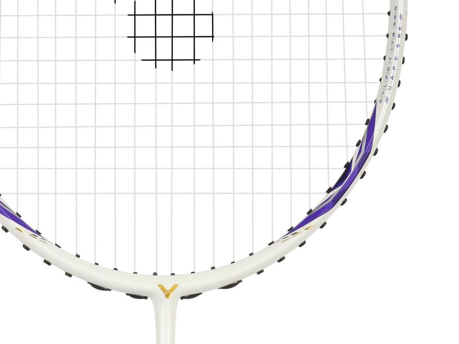 Close-up of the Victor Auraspeed 7100 4U Badminton Racket by Victor, featuring purple and gold accents on a white frame. The image highlights the strings and upper frame against a plain white background. Ideal for beginners.