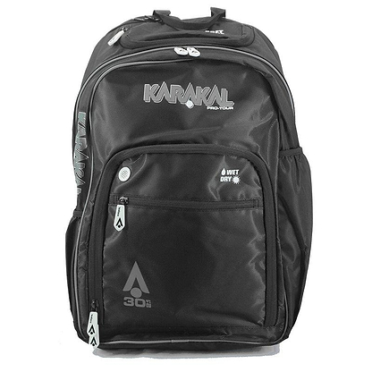 The Karakal Pro Tour 30 2.1 Badminton Backpack in black and white offers multiple compartments with "30L" and wet/dry compartment labels. Its sleek design includes padded shoulder straps, reinforced zippers, and side pockets, making it perfect for sports or travel.
