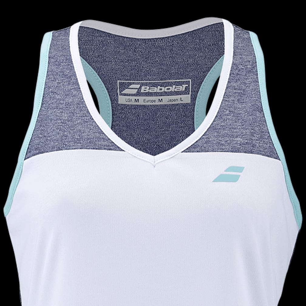 The Babolat Play Women's Badminton Tank Top showcases a stylish sleeveless design with the Babolat Play logo on the front. It features a white lower section combined with a denim-colored upper section, highlighted by light blue trim along the shoulders. The FiberDry technology ensures you stay cool and dry, while the inside tag provides sizing details.