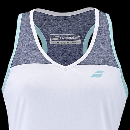 The Babolat Play Women's Badminton Tank Top showcases a stylish sleeveless design with the Babolat Play logo on the front. It features a white lower section combined with a denim-colored upper section, highlighted by light blue trim along the shoulders. The FiberDry technology ensures you stay cool and dry, while the inside tag provides sizing details.