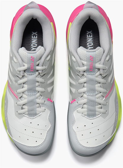 A pair of Yonex Subaxia GT Women's Badminton Shoes in light grey with pink and yellow accents, featuring GRPHT THRTTL technology, shown from above on a white background.