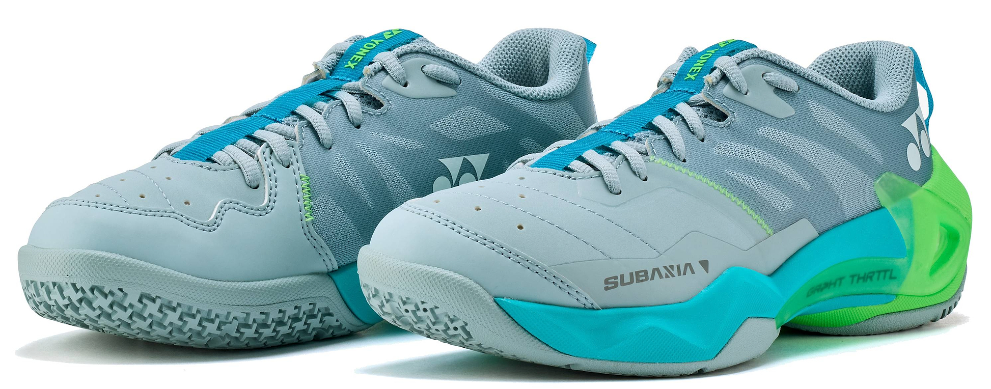 The Yonex Subaxia GT 2026 Women's Badminton Shoes in Grayish Green feature GRPHT THRTTL technology, a textured sole, blue laces, and Yonex branding on the sides and heel.