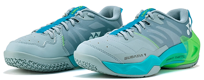The Yonex Subaxia GT 2026 Women's Badminton Shoes in Grayish Green feature GRPHT THRTTL technology, a textured sole, blue laces, and Yonex branding on the sides and heel.