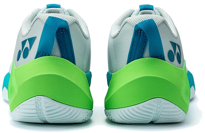 A pair of Yonex Subaxia GT 2026 Men's Badminton Shoes by Yonex, shown from the back, featuring white uppers, blue pull tabs, bright green heels with a dark blue logo, and grippy pale green soles—ideal for badminton matches.