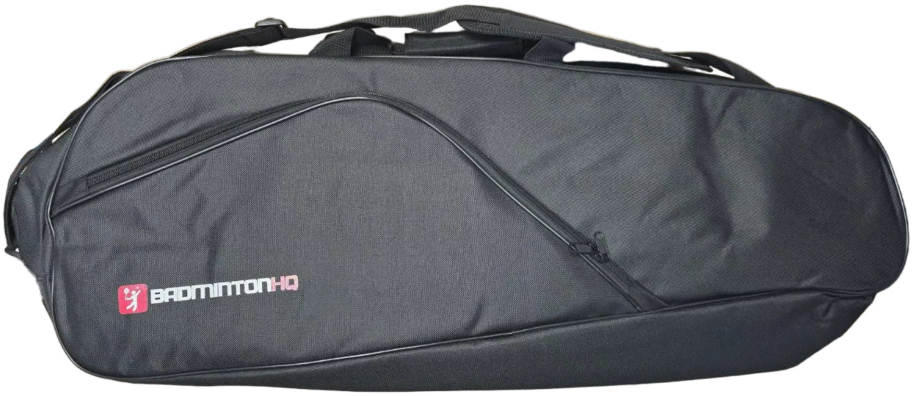 The BadmintonHQ 3 Racket Badminton Bag in black features a curved zipper pocket, top handle, and fits up to 3 rackets. "BADMINTON HQ" logo and text in white and pink are printed on the left side.