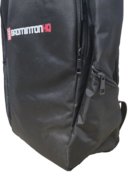 The BadmintonHQ Badminton Backpack - Black features multiple zippered pockets, a visible side pocket, and the "BADMINTONHQ" logo in white and red—ideal as a stylish badminton kit bag.