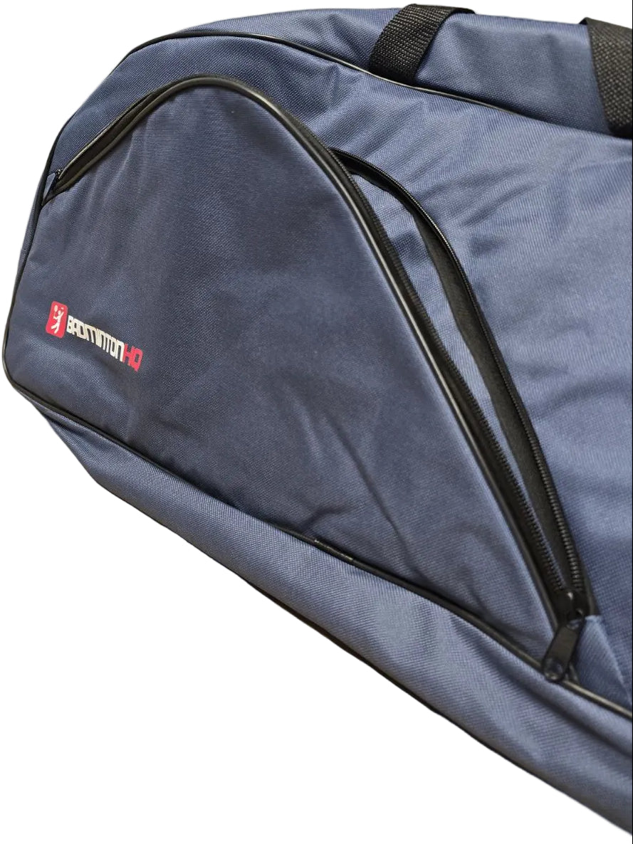 A close-up of the BadmintonHQ 3 Racket Badminton Bag in blue, featuring black zippers and handles, with the "BadmintonHQ" logo in white and red displayed on the side.