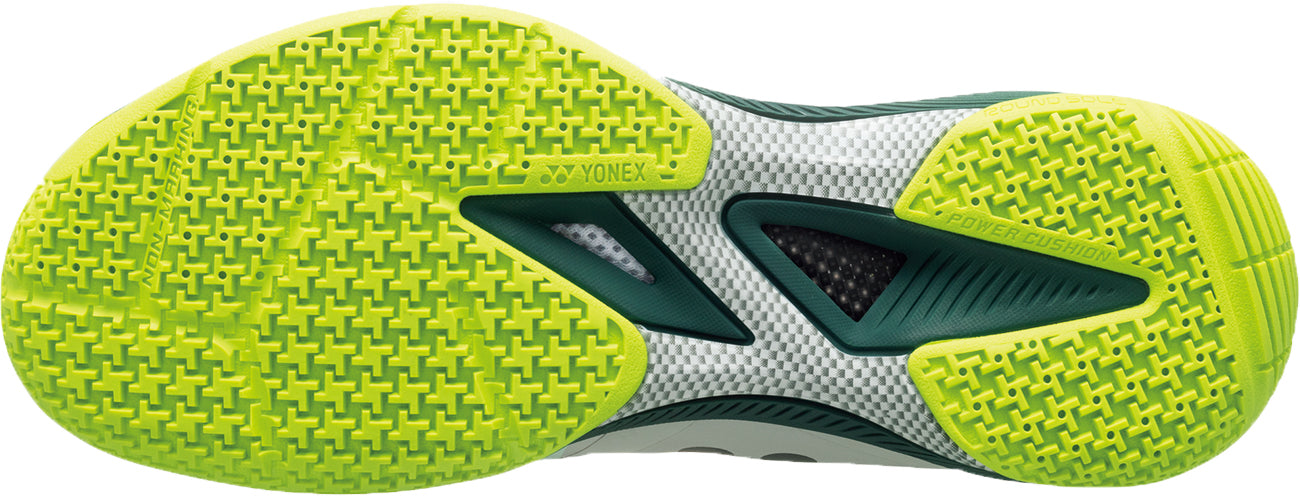Close-up of the Yonex Power Cushion 65Z4 Viktor Axelsen Men's Badminton Shoes sole in white/lime, showing a textured yellow-green grip with "POWER CUSHION" and Yonex branding—designed for top badminton performance.