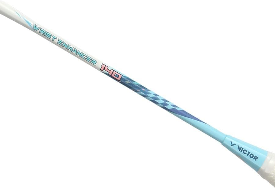 A close-up of the Victor Wrist Enhancer 140 M Training Badminton Racket in white, showing "FAST ENHANCER 140" and "VICTOR" branding with a geometric blue pattern on the heavy graphite shaft.