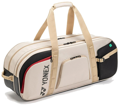 The Yonex BA72631WEX Gearlogic Tournament Badminton Bag in beige features multiple zippered compartments, tan handles and accents, and the Yonex logo on the side.