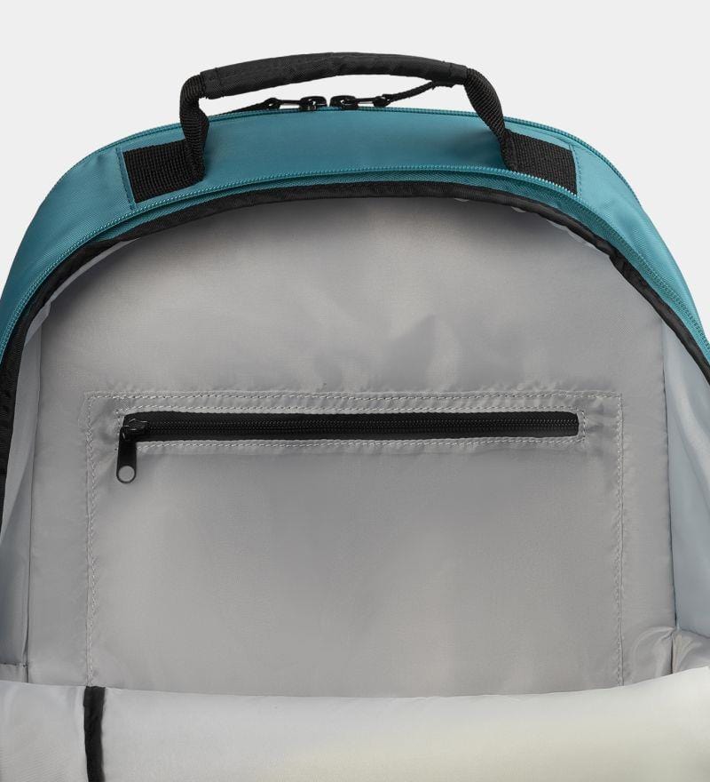 Close-up of the Dunlop SX Club Badminton Backpack's interior reveals a zippered compartment against a light grey lining. The teal top has black accents on the handle and zippers, padded straps for comfort, and a special racket compartment for convenience.