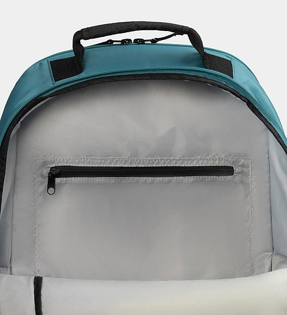 Close-up of the Dunlop SX Club Badminton Backpack's interior reveals a zippered compartment against a light grey lining. The teal top has black accents on the handle and zippers, padded straps for comfort, and a special racket compartment for convenience.