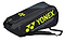 The Yonex 02326EX Expert 6 Racket Badminton Bag in black and yellow comes with convenient backpack straps and proudly displays the Yonex logo and text on its side. It is designed with multiple compartments for ample storage, including a dedicated shoe compartment for all your sports equipment needs.