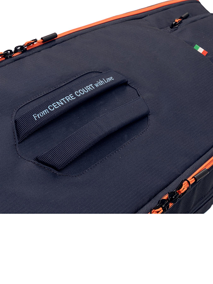 Close-up of the HEAD Pro 9 Racket Badminton Bag L - Navy by HEAD featuring orange zippers, CCT+ climate control, a handle with "From CENTRE COURT with Love," and a small Italian flag patch nodding to Jannik Sinner.