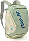 The Yonex 02612EX Expert Badminton Backpack in Smoke Green features padded shoulder straps, a top handle, multiple zippered compartments, and blue Yonex logos—a stylish and practical choice for carrying your badminton gear.