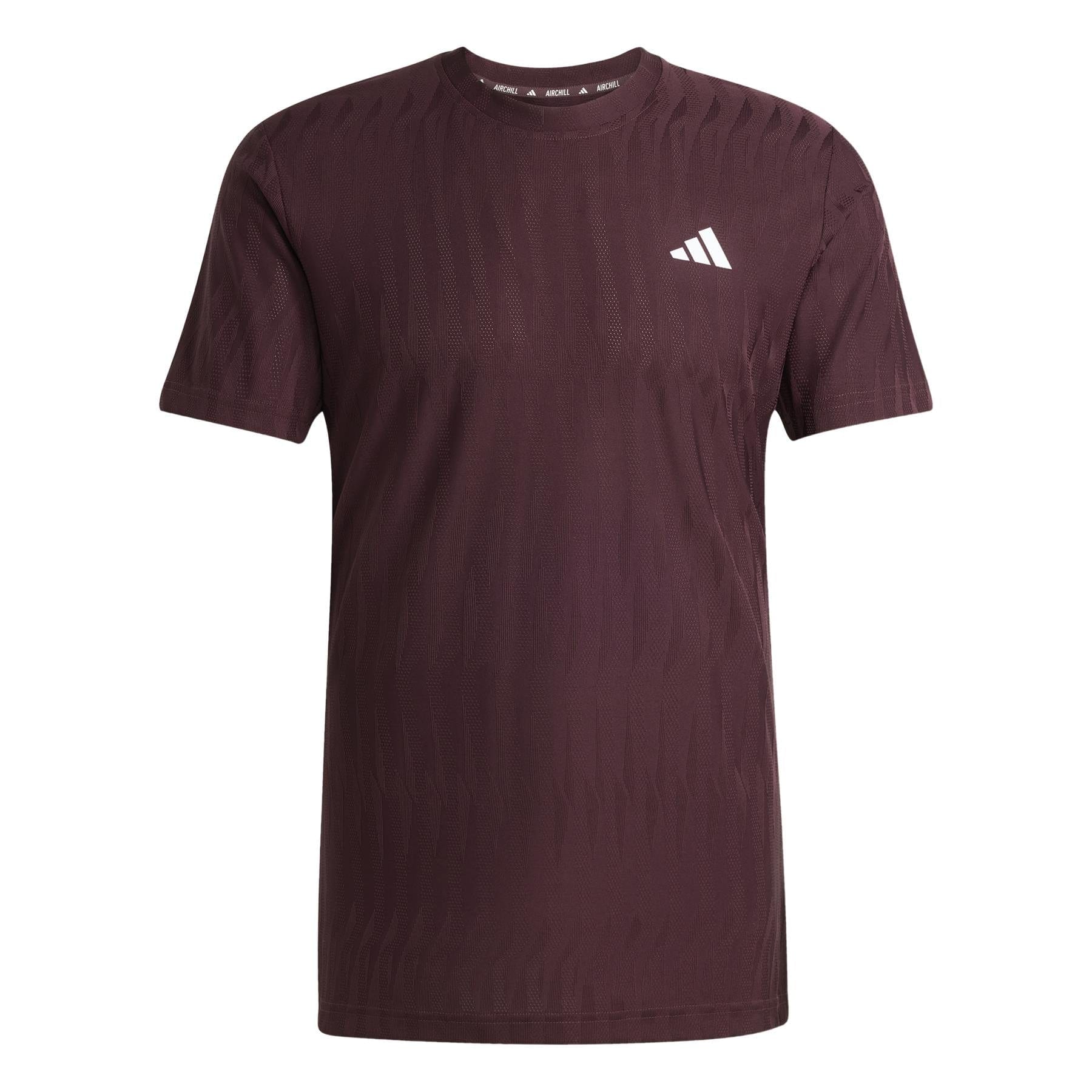 The ADIDAS Men's Climacool+ Freelift Badminton T-Shirt in Ruby features a subtle textured pattern perfect for badminton practice, with a small white adidas logo on the upper left chest.