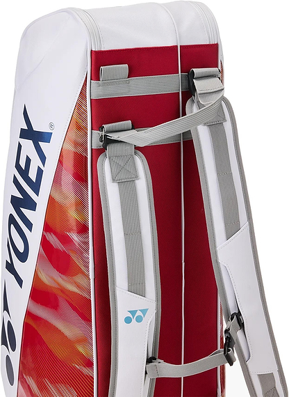A close-up of the Yonex 02626EX Expert 6 Racket Badminton Bag in white, featuring red and orange accents, dual adjustable gray shoulder straps, Thermo Guard technology, and the Yonex logo on the side.