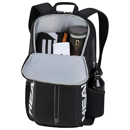 The HEAD Tour Badminton Backpack in black and white features an open main compartment containing a folded towel, a clear sports bottle, and a smaller open pocket. A specialized racket compartment ensures your gear stays organized, with the brand name "HEAD" prominently displayed on the bag.