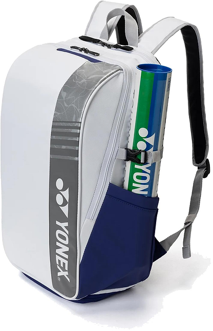 The Yonex BA52512EX Club Badminton Backpack in white/blue features a gray logo, padded straps, a side zipper, and a side pocket holding two Yonex shuttlecock tubes. Durable and convenient for players.
