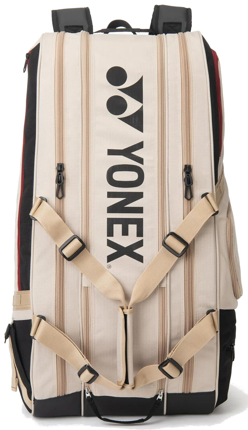 The Yonex BA72629EX Gearlogic 9 Racket Badminton Bag in beige features black straps, zippers, and bold Yonex branding. It offers multiple adjustable straps and side pockets, making it perfect for carrying all your badminton essentials.