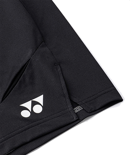 Close-up of Yonex 15239YX Knit Men's Badminton Shorts in black, featuring a white Yonex logo near the lower left seam and pocket. The breathable, textured fabric makes these shorts ideal for lightweight comfort on court.