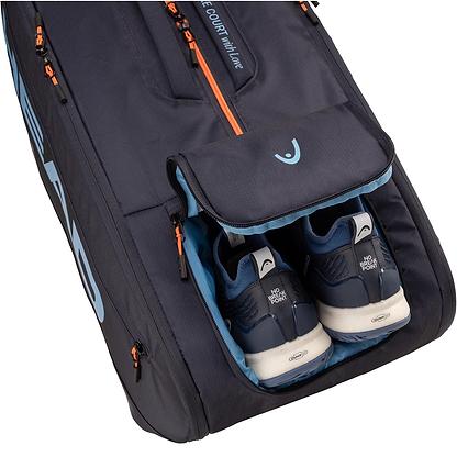 A close-up of the HEAD Pro 12 Racket Badminton Bag XL - Navy shows its open compartment with navy athletic shoes featuring white soles and “NO FOR” on the heel tabs, plus light blue accents for a tournament-ready look.