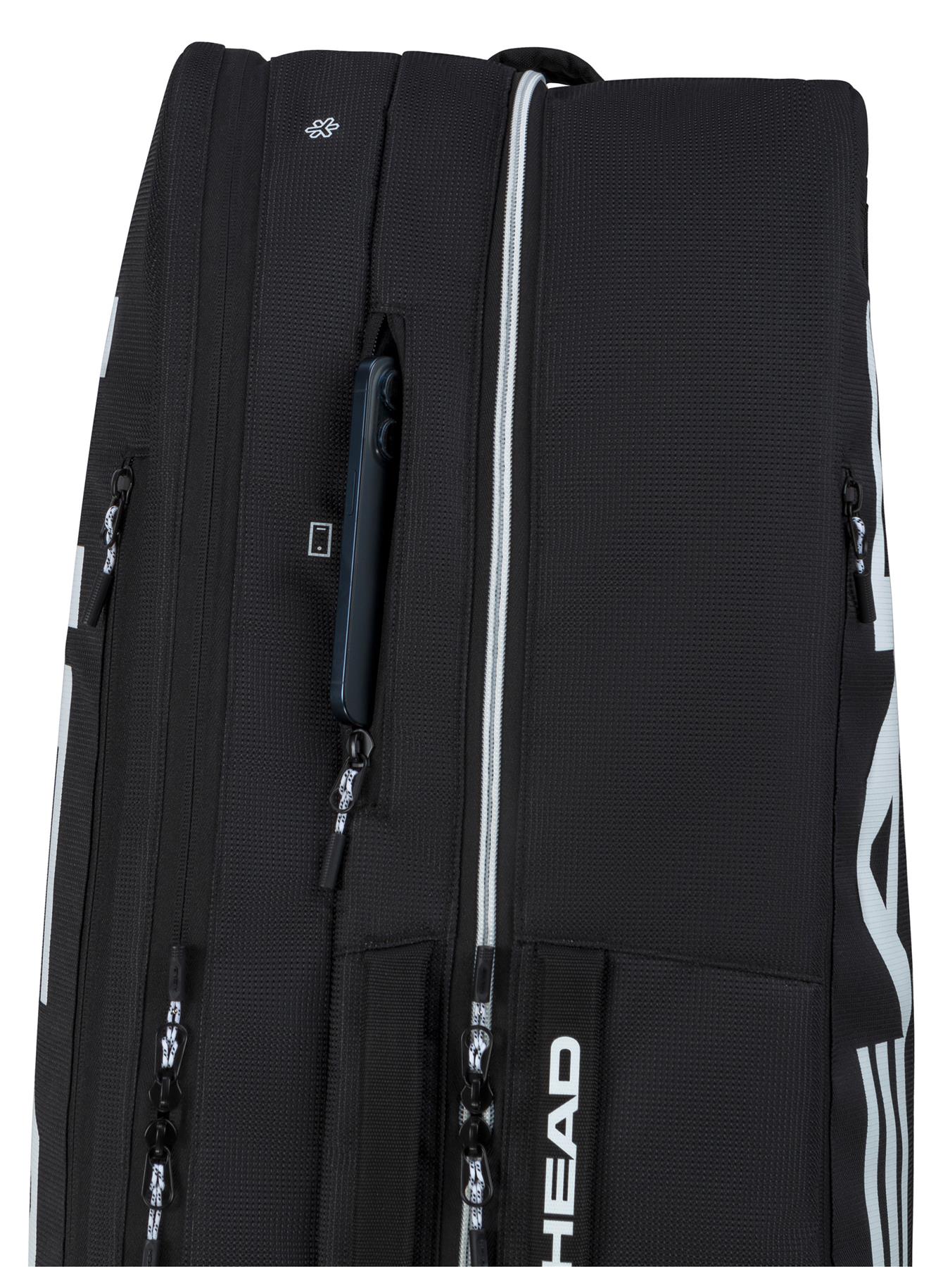 A close-up of the HEAD Tour 9 Racket Badminton Bag L - Black by HEAD shows multiple zippered compartments, white accents and branding, CCT+ climate control, and a partially open pocket revealing a smartphone.