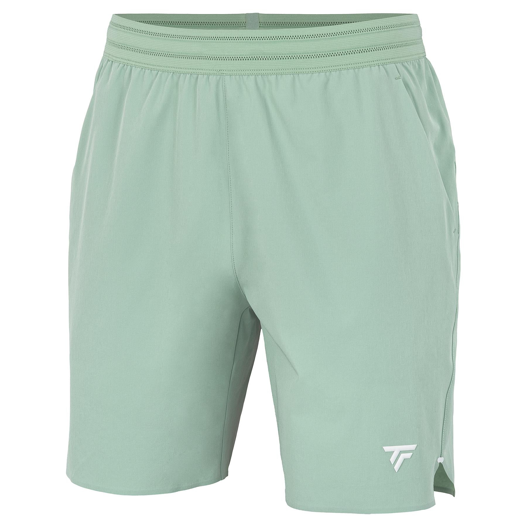 The Tecnifibre Team Stretch Men's Badminton Shorts in sage green feature an elastic waistband, lightweight breathable fabric, and a small white logo on the lower left leg.